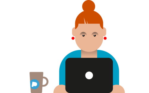 Es sitzt eine junge Frau mit roten Haaren an einem Laptop, neben ihr steht eine Tasse.